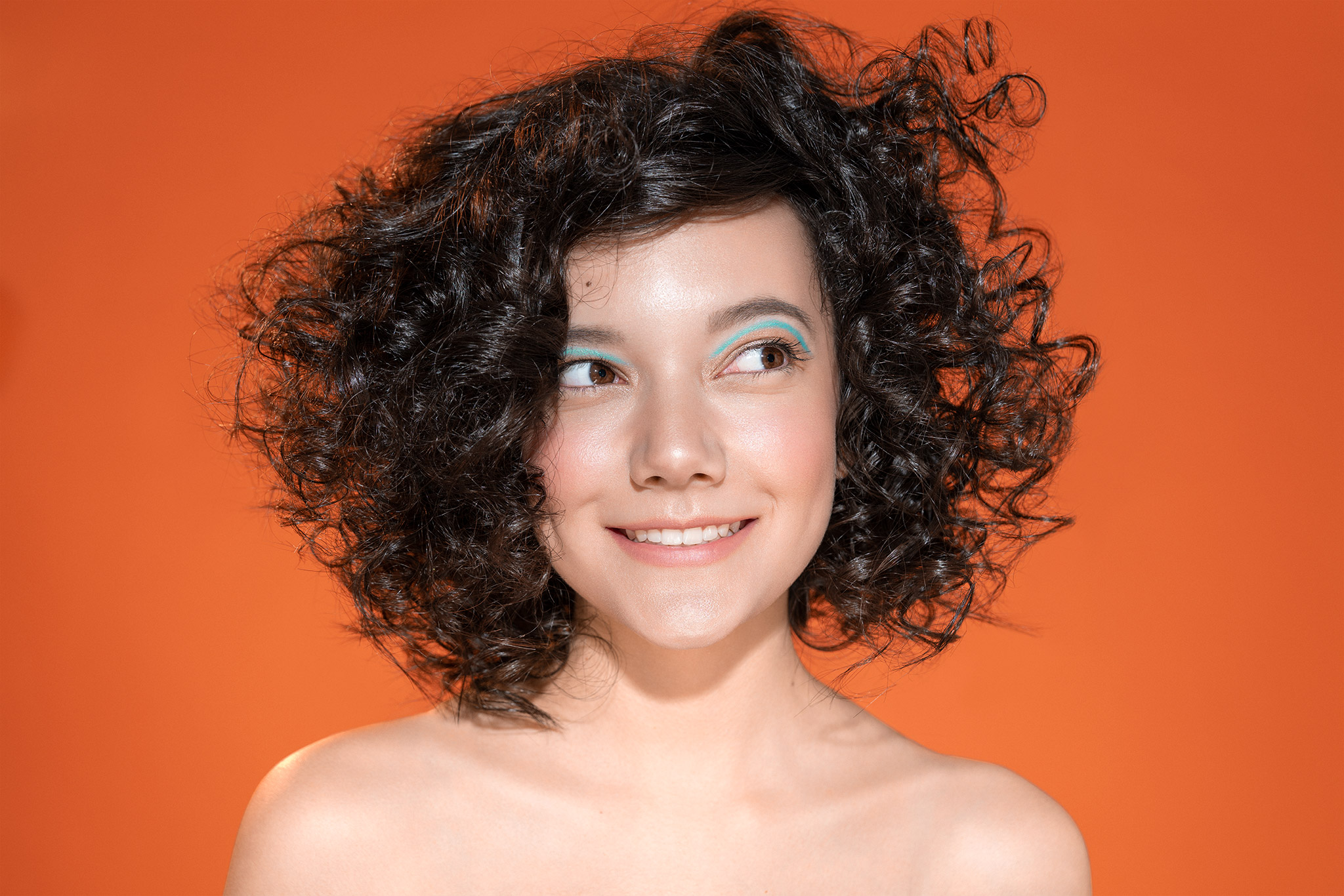 Yulia Curly Hair Orange Background Blue Eyeliner Alexander Croft