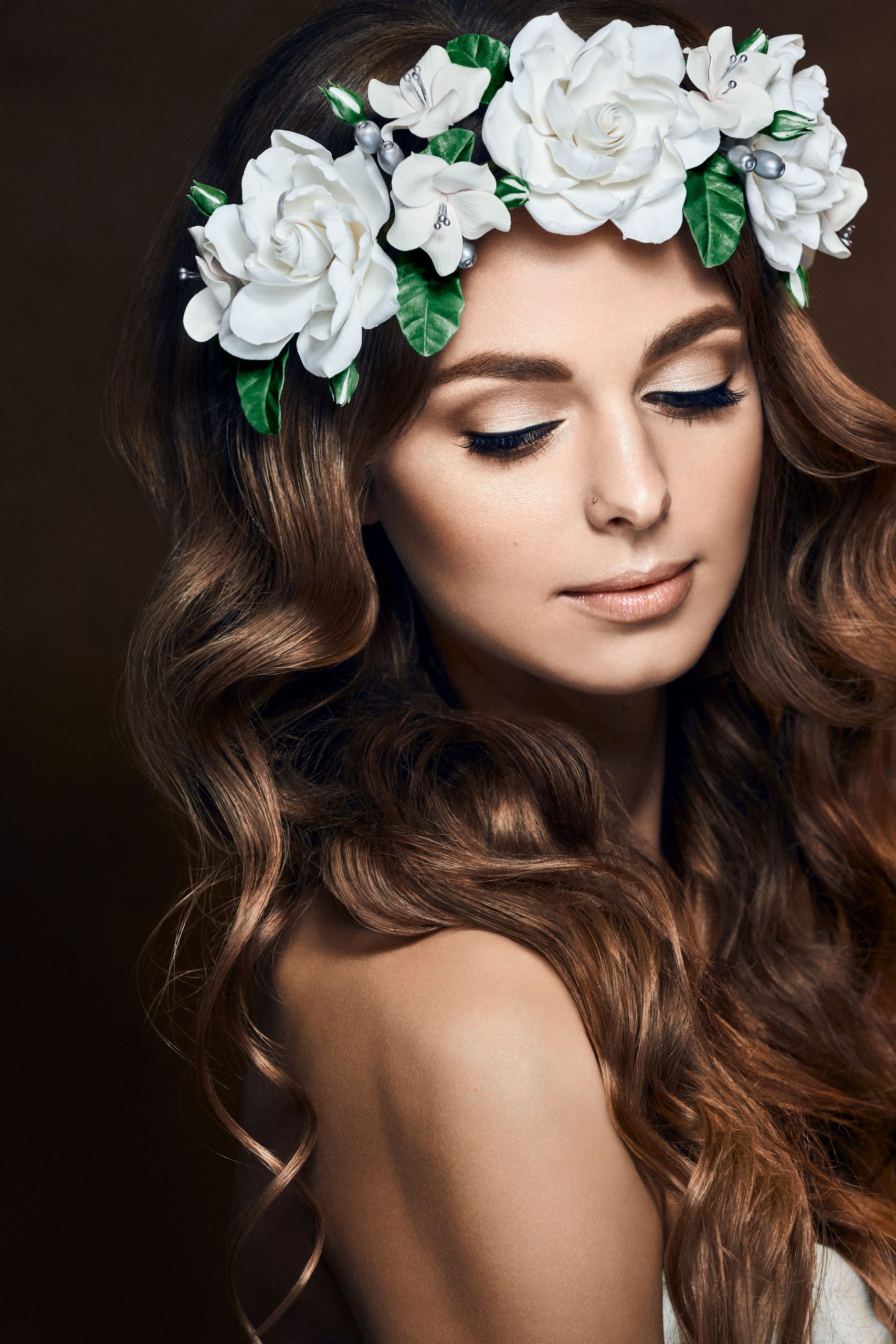 Woman with white flower crown in long honey brown hair